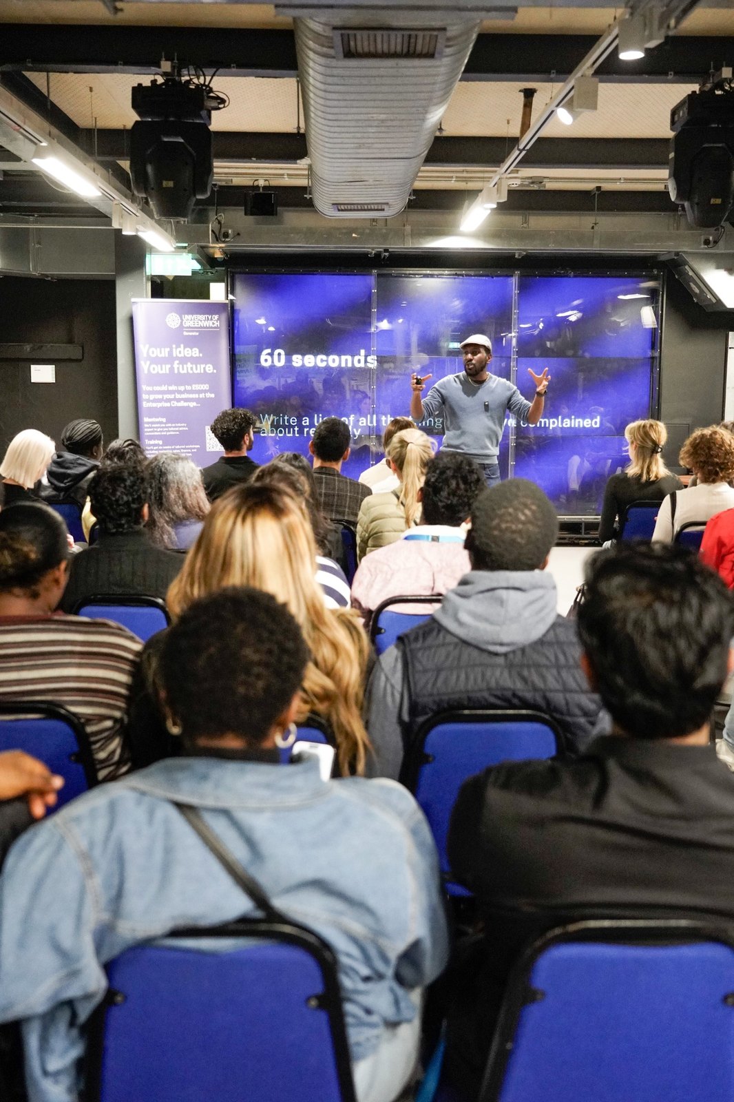 Presenter speaking to a packed audience at the Enterprise Challenge launch event.